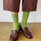 model wearing cactus green ribbed crew socks with brown shoes