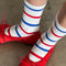 up close of model wearing white socks with blue and red alternating stripes