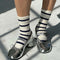 up close of model wearing white socks with navy stripes