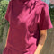 model wearing cabernet colored short sleeve mock neck top