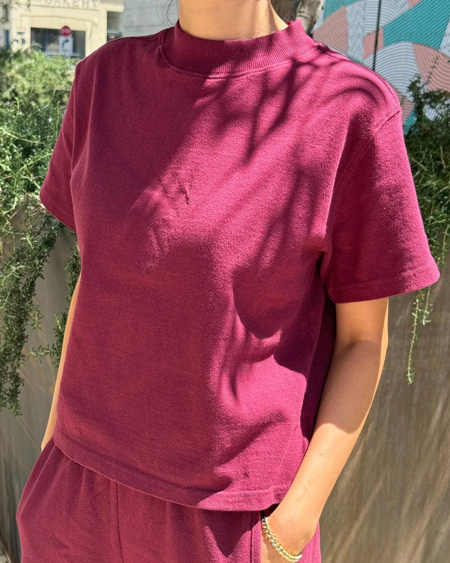 model wearing cabernet colored short sleeve mock neck top