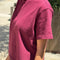 side view of model wearing cabernet colored short sleeve mock neck top