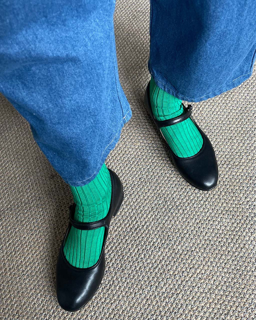 model wearing pair of kelly green socks