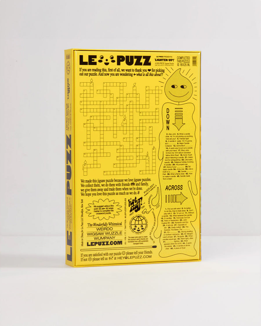 back view of boxed le puzz 500 piece puzzle with various novelty lit candles