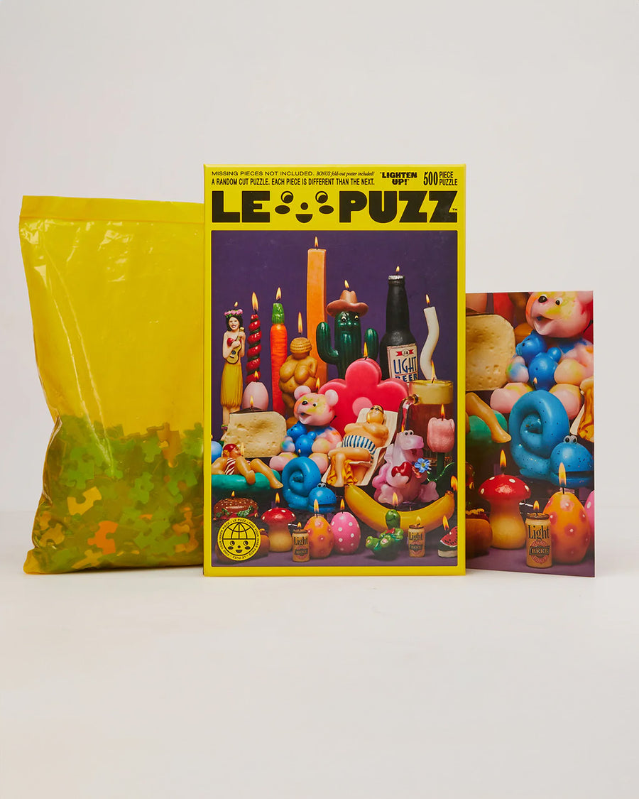 le puzz 500 piece puzzle with various novelty lit candles with poster, box, and bag of puzzle pieces