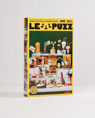 boxed le puzz 500 piece puzzle with various 'fake foods' being poured