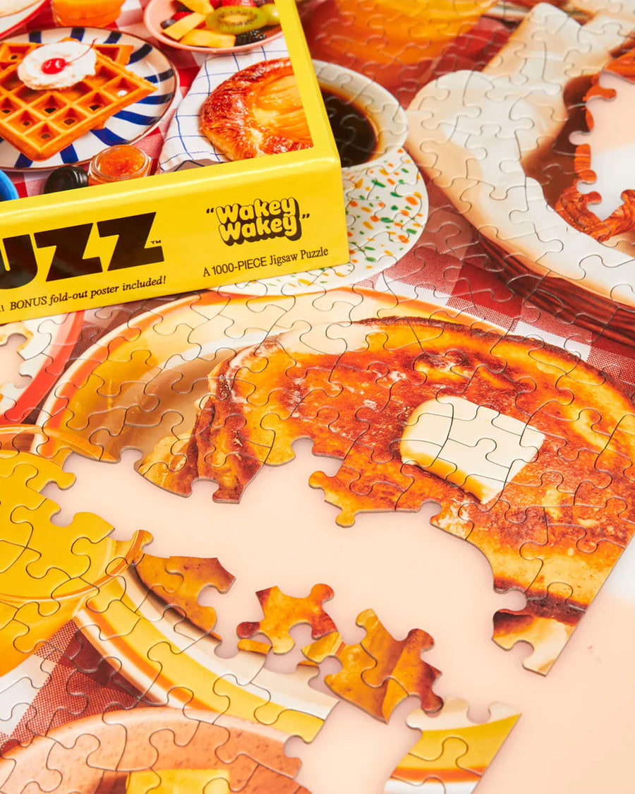 up close of le puzz 10 piece puzzle with various breakfast foods displayed