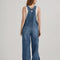 back view of model wearing medium denim overalls with front pocket and lee tag