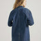 back view of model wearing medium denim chore coat with four front patch pockets and button front