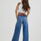 back view of model wearing medium denim a-line trouser