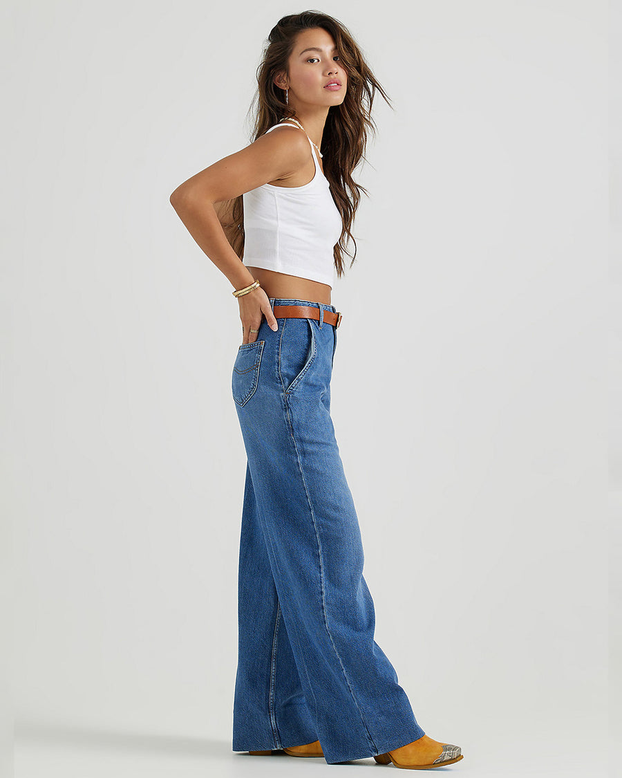 side view of model wearing medium denim a-line trouser