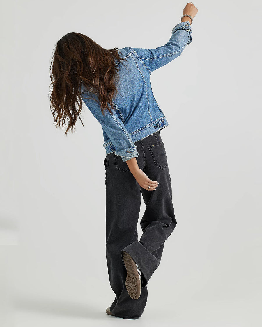 back view of model wearing black denim a-line trouser