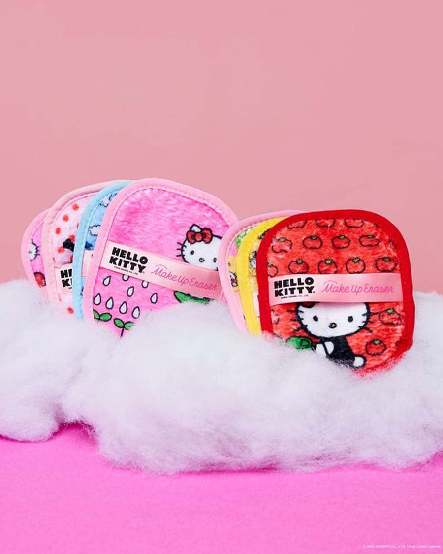 set of 7 various hello kitty reusable makeup wipes with laundry bag against pink ground and sitting on 'clouds'