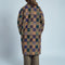 back view of model wearing brown mid length coat with front lapel, button front and colorful checkered patches