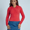 model wearing red fuzzy textured long sleeve polo neck top