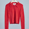 red fuzzy textured long sleeve polo neck top on a hanger