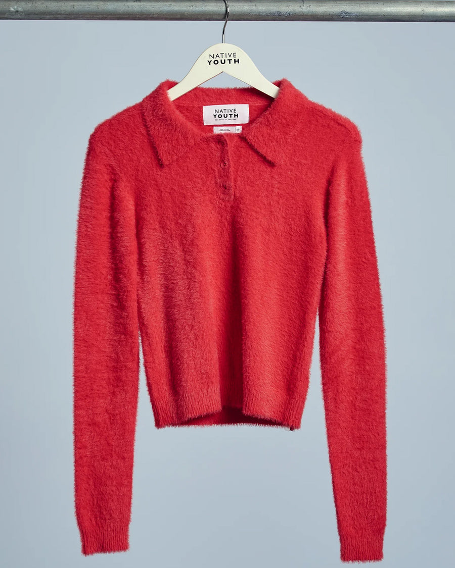 red fuzzy textured long sleeve polo neck top on a hanger