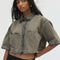 model wearing cropped chocolate acid wash button down top with heart shaped front pockets