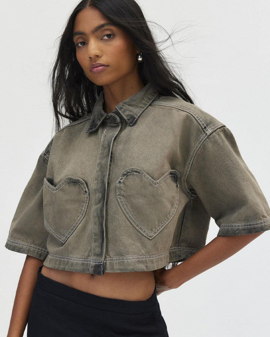 model wearing cropped chocolate acid wash button down top with heart shaped front pockets