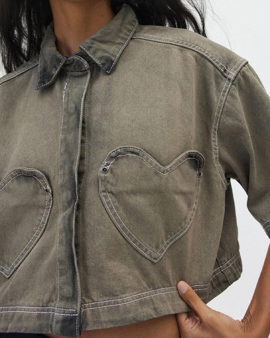 up close of model wearing cropped chocolate acid wash button down top with heart shaped front pockets