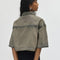 back view of model wearing cropped chocolate acid wash button down top with heart shaped front pockets