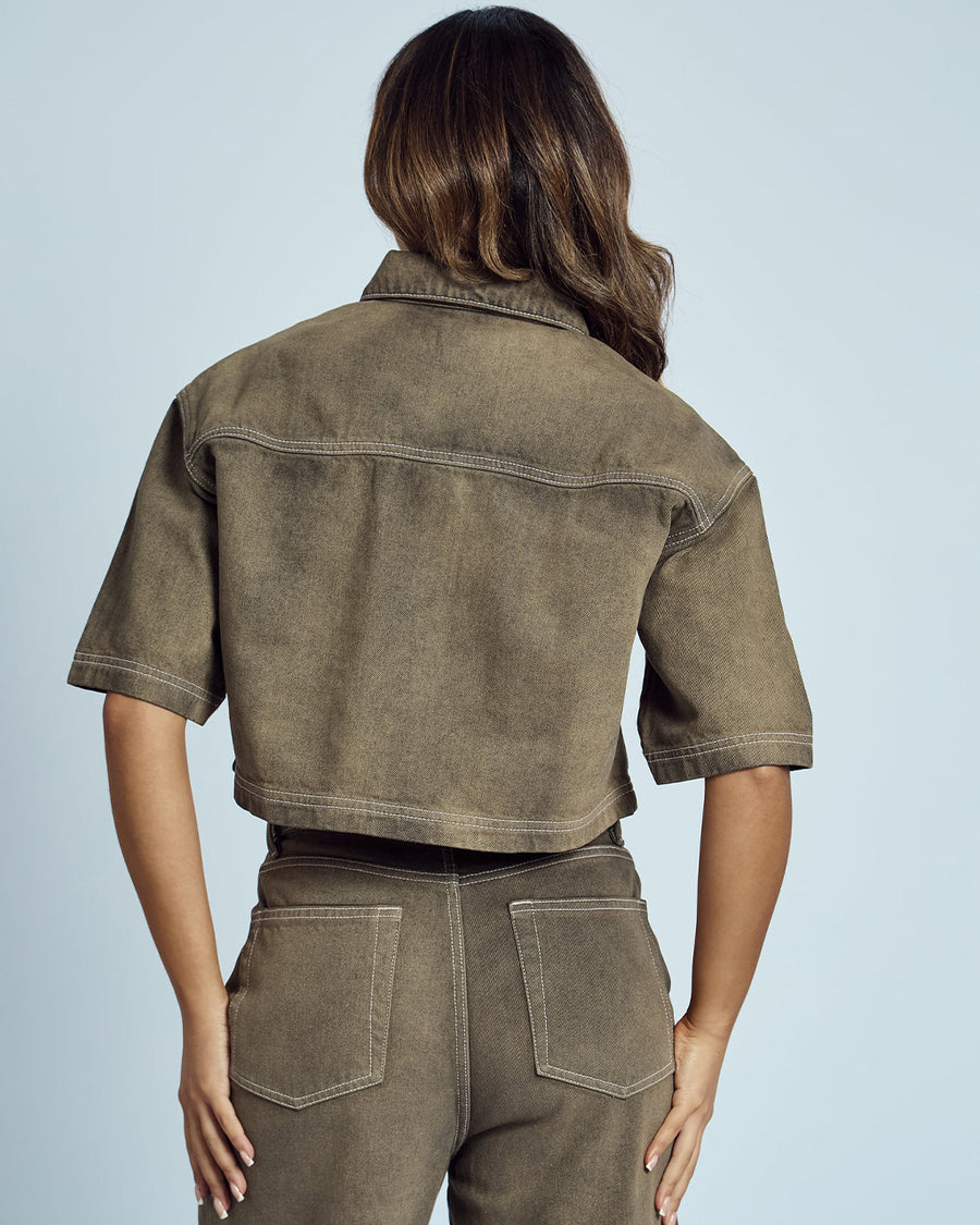 back view of model wearing cropped chocolate acid wash button down top with heart shaped front pockets