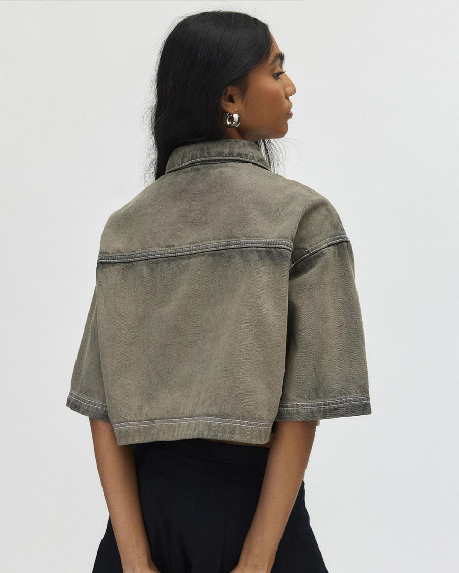 back view of model wearing cropped chocolate acid wash button down top with heart shaped front pockets