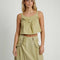 model wearing moss cropped linen tank with ruffle bust detail and matching midi skirt