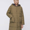 up close of model wearing green knee length puffer coat with patch pockets and hood