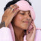 model removing blush pink weighted sleep mask from their eyes