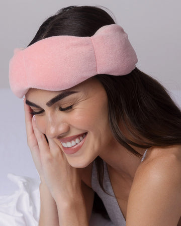 model wearing blush pink weighted sleep mask