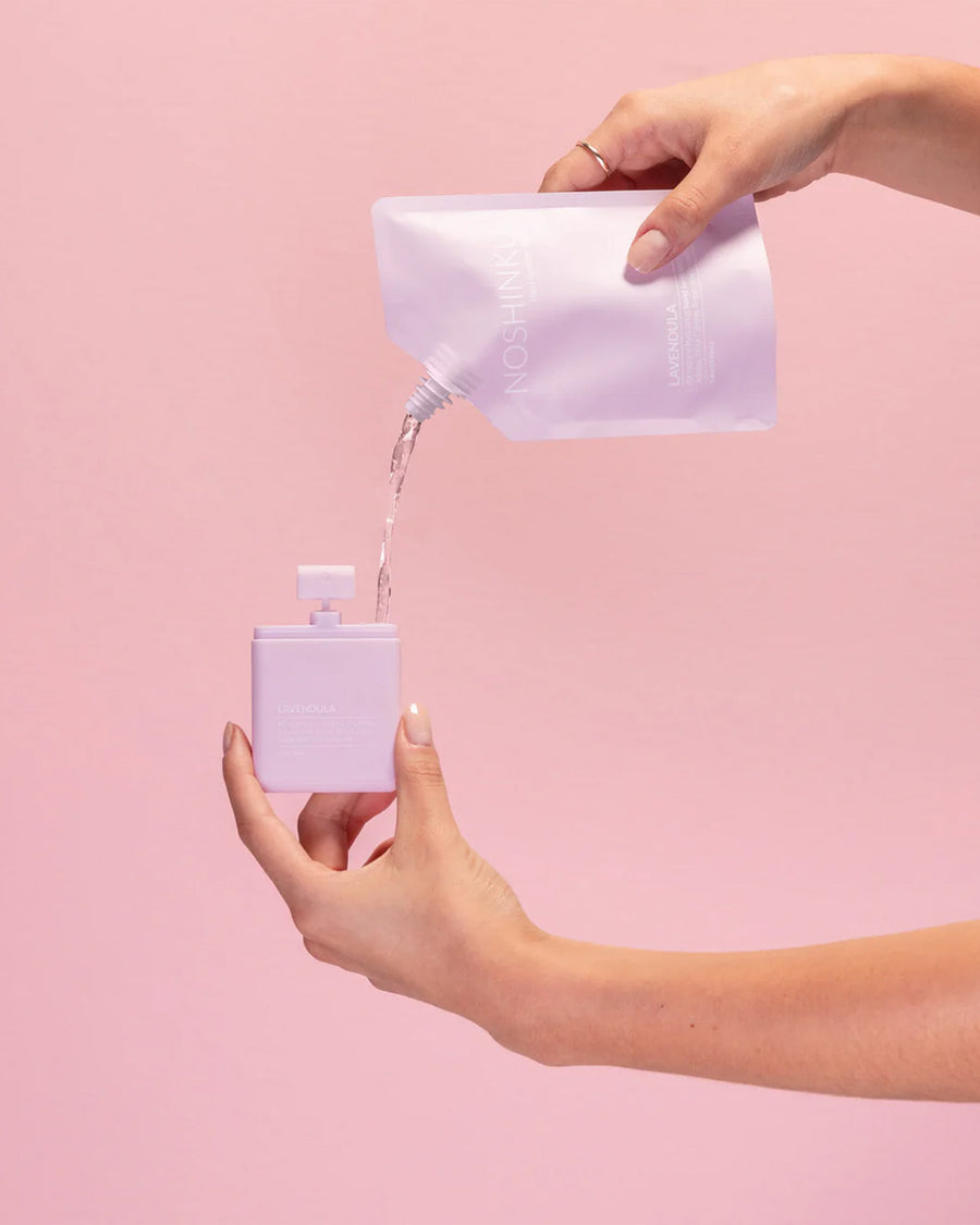 model pouring refill into lavender hand sanitizer