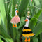 hanging pair of two mismatched duck earrings: goose in a flower costume and goose in a bee costume