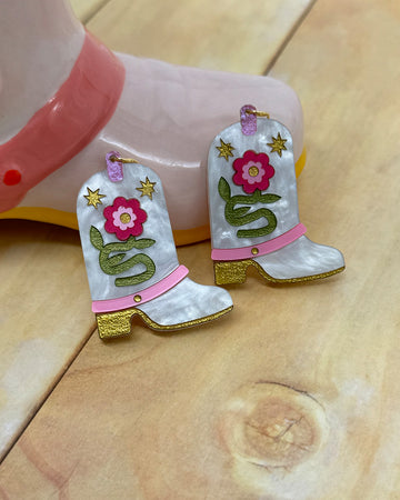 white pearl cowboy boot earrings with pink flowers and colorful glittery accents