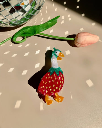 hair claw with goose wearing a strawberry outfit