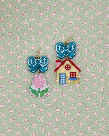 earrings with blue bow studs and pink tulip dangle and yellow house dangle