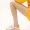 model wearing aqua sneaker with yellow and hot pink trim detail and yellow shoe laces