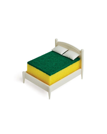 white mini bed frame with green and yellow kitchen sponge on it