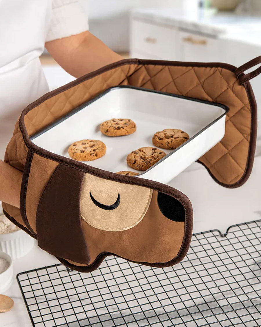 long brown dog oven mitt around cookie tray