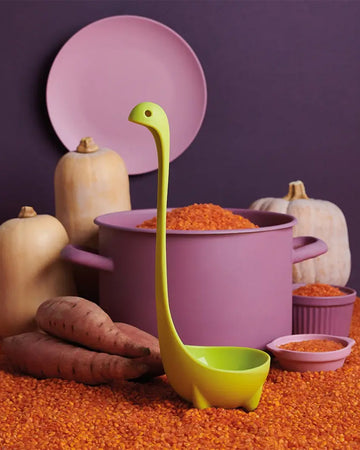 green jumbo nessie ladle on a table with grains