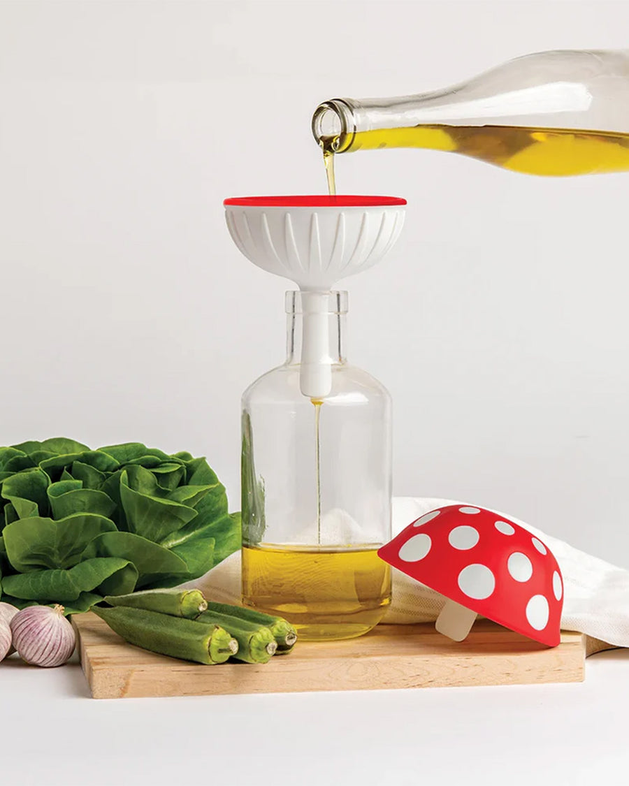 model pouring oil through silicone XL red mushroom funnel