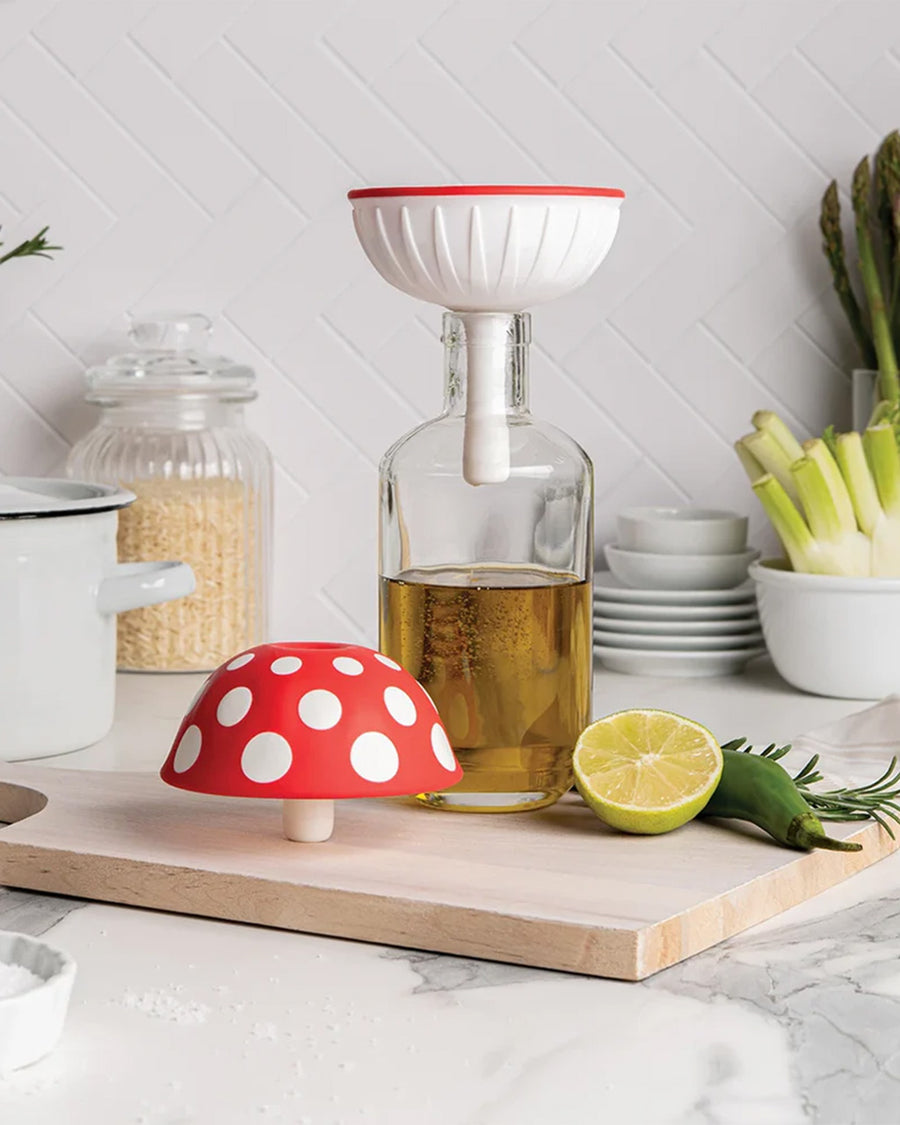 silicone XL red mushroom funnel on a glass bottle