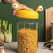 model pulling lid off of small yellow monster pasta holder