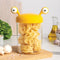 small yellow monster pasta holder with pasta inside