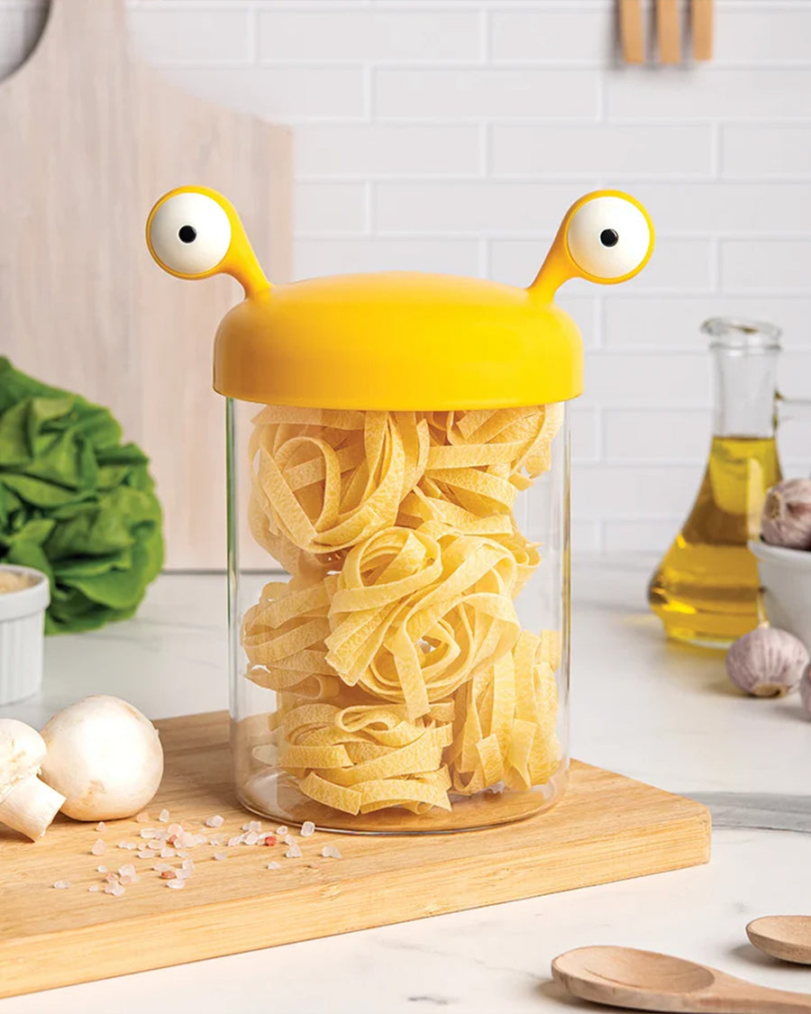 small yellow monster pasta holder with pasta inside