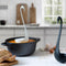 white swan floating ladle in a black pot