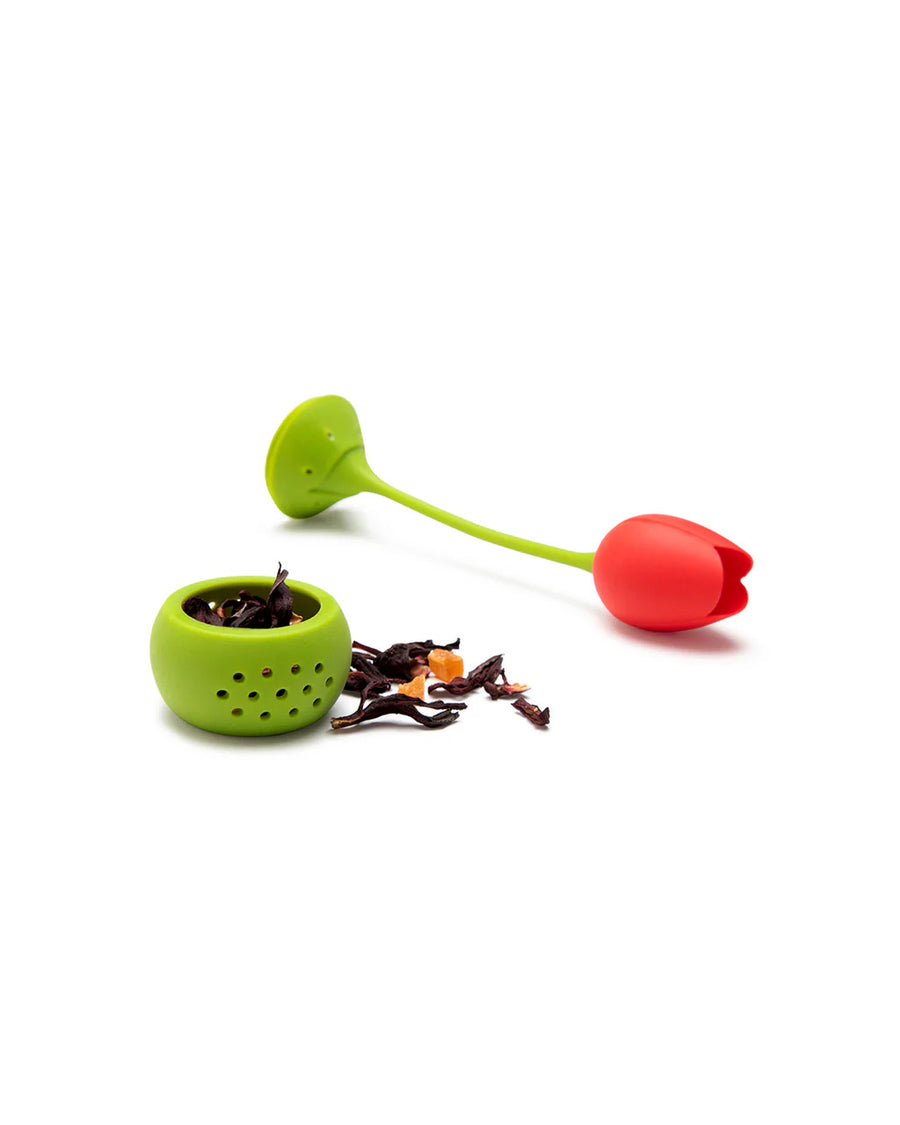 red tulip tea infuser with tea next to it