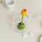 top view of yellow tulip infuser in a clear cup