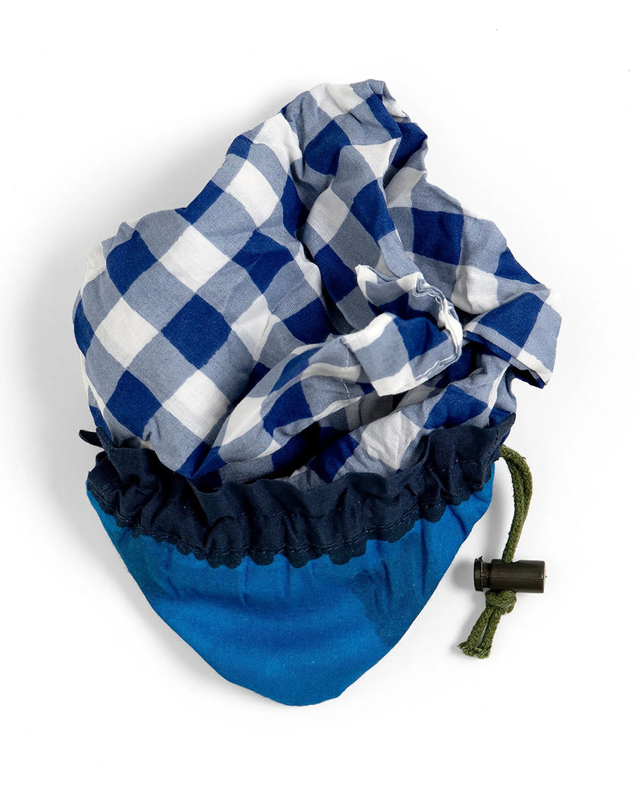 packed blue gingham market bag with green strap and blueberry bag peeking out