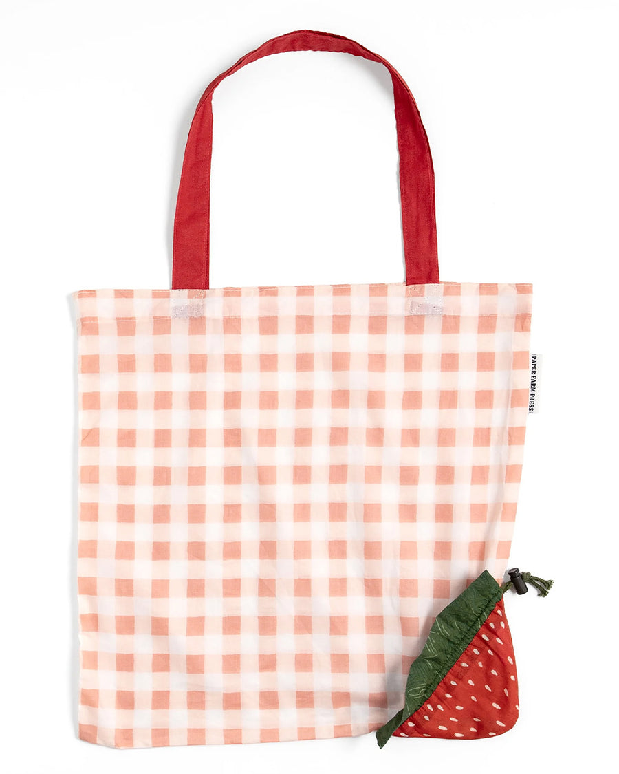 red gingham market bag with red strap and strawberry bag